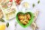 Girasoli pesto e stracchino senza lattosio con datterini arrosto, zucchine al limone e crumble croccante al basilico